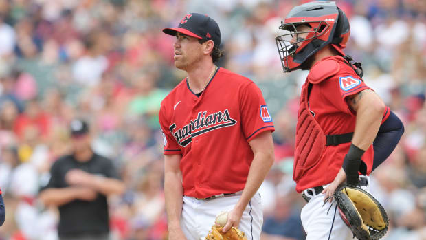 Jul 9, 2023; Cleveland, Ohio, USA; Cleveland Guardians starting pitcher Shane Bieber (57) and catcher Cam Gallagher (35) look to the scoreboard during the sixth inning against the Kansas City Royals at Progressive Field. Mandatory Credit: Ken Blaze-USA TODAY Sports